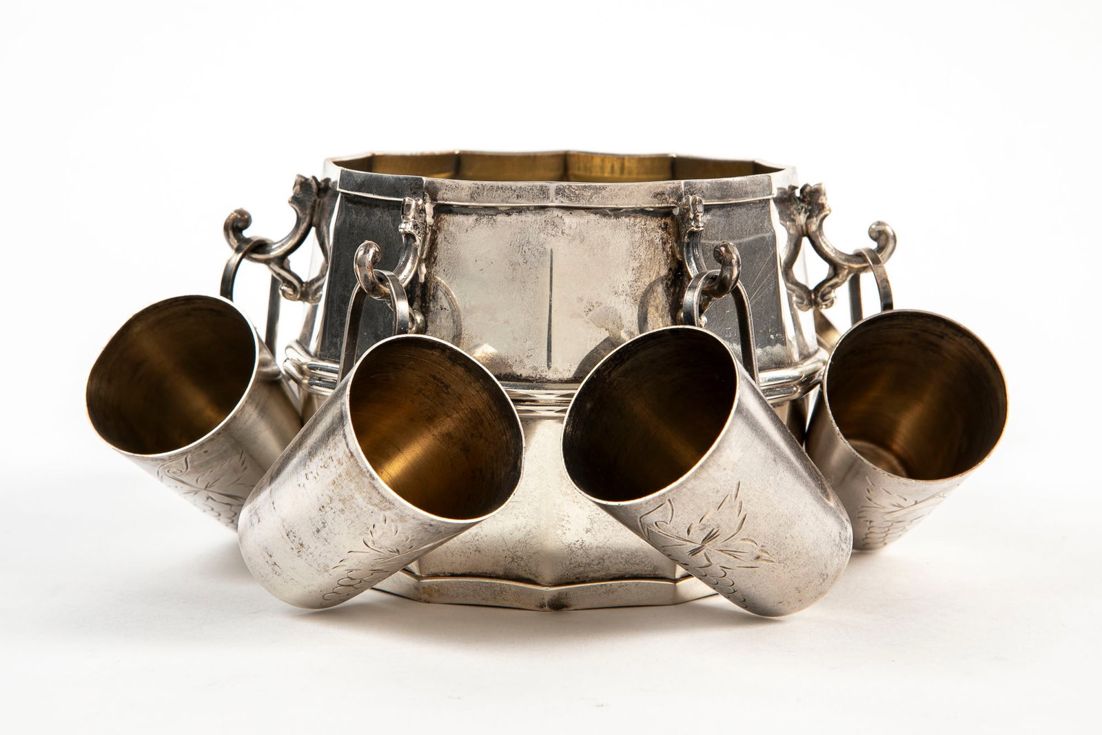 A silver desk set including a central barrel-shaped vessel, hallmarked 'Kapriya 925', the interior: A silver desk set including a central barrel-shaped vessel, hallmarked 'Kapriya 925', the interior of the barrel is gilded, from which hang six Russian Soviet silver cups, hallmarked 875, total weight
