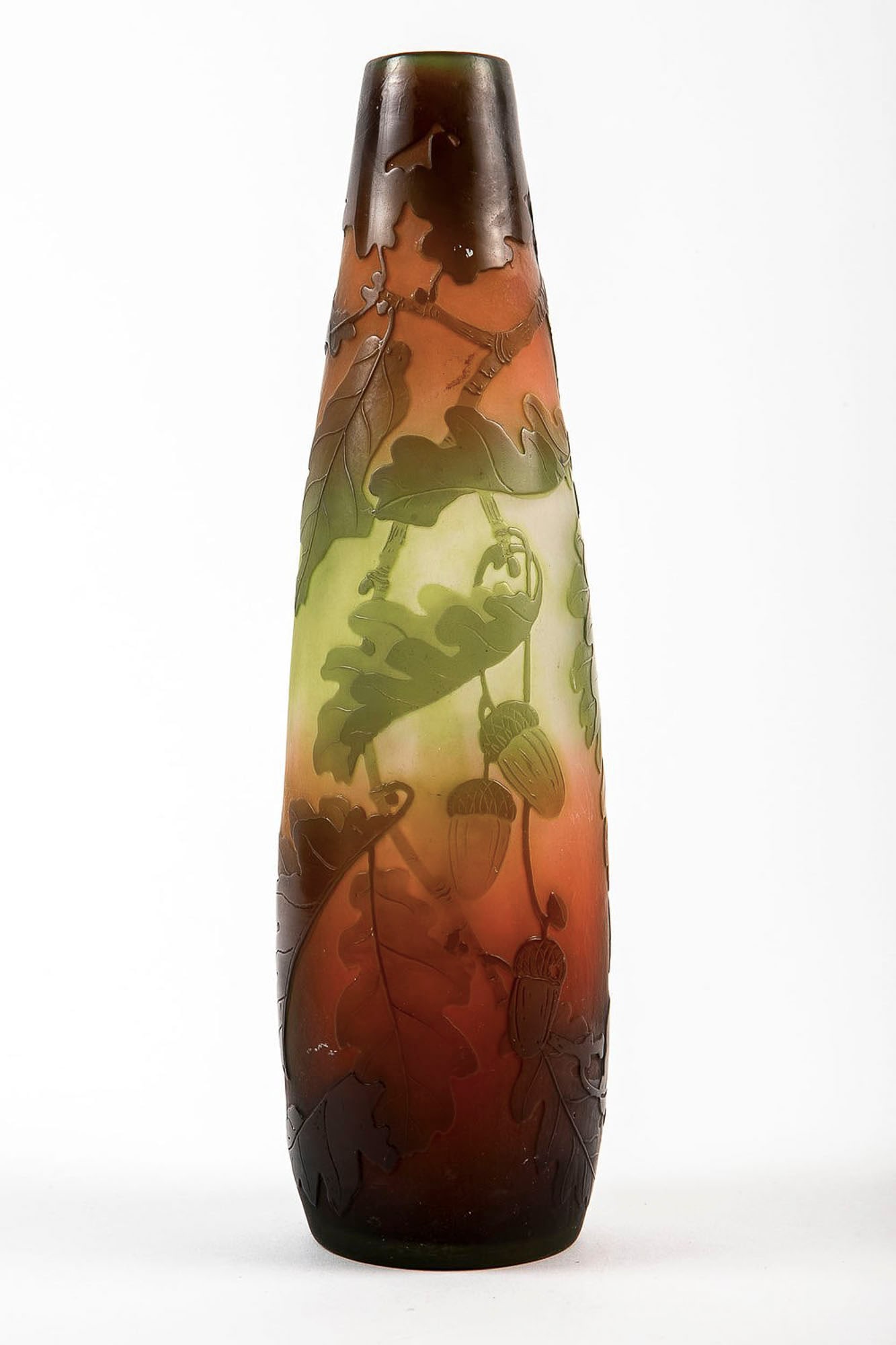 A French Art Nouveau glass vase, circa 1900, made by Emile Galle, decorated and signed with a cameo,: A French Art Nouveau glass vase, circa 1900, made by Emile Galle, decorated and signed with a cameo, in a pattern of oak branches and acorns, Height: 27.5 cm, Width: 8 cm,