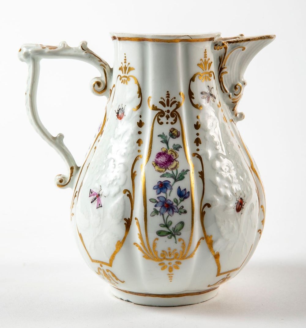 An antique German porcelain milk jug from the 18th century (circa 1740-1750), made in Meissen, made: An antique German porcelain milk jug from the 18th century (circa 1740-1750), made in Meissen, made of porcelain decorated with hand paintings of flowers in enamel and gold, signed, two small chips to