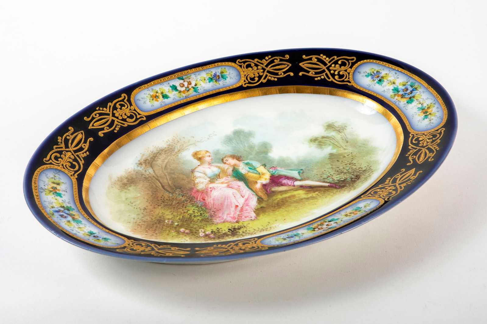 An antique French oval porcelain plate, made by Sevres, signed and dated 1848, decorated with hand: An antique French oval porcelain plate, made by Sevres, signed and dated 1848, decorated with hand paintings, signed on the back and signed by the artist, Length: 19.5 cm Width: 28.5 cm,