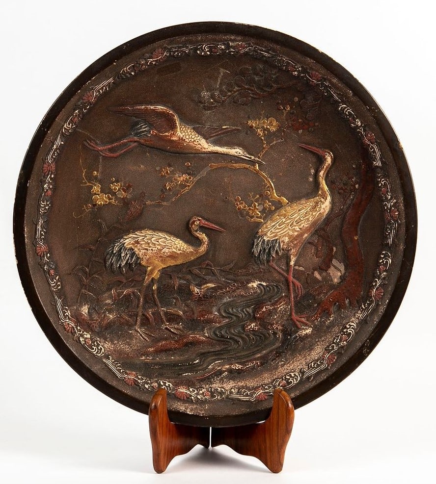 An antique Japanese terracotta plate from the 19th century (Meiji period), decorated with the image: An antique Japanese terracotta plate from the 19th century (Meiji period), decorated with the image of three Manchurian storks, can be hung on the wall, scuffs and blemishes, Diameter: 41 cm,
