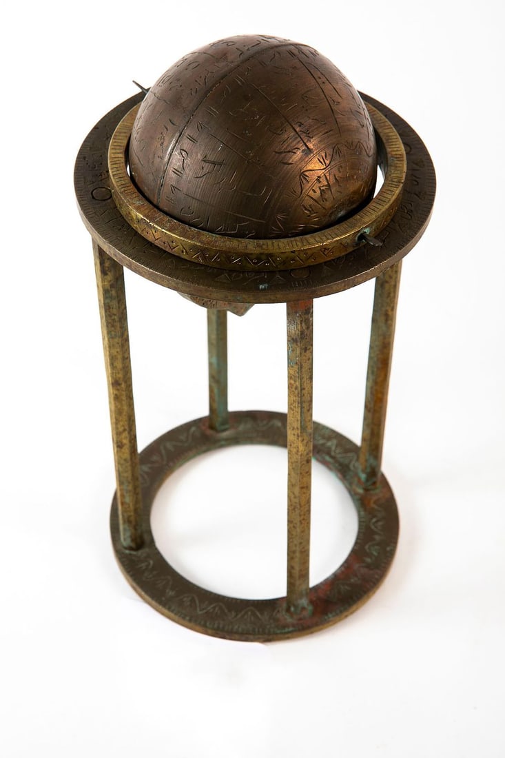 A Persian Hindu ball (ispra), decorated with the names of celestial bodies, made of bronze and: A Persian Hindu ball (ispra), decorated with the names of celestial bodies, made of bronze and brass, Total height: 26 cm, base diameter: 14 cm,