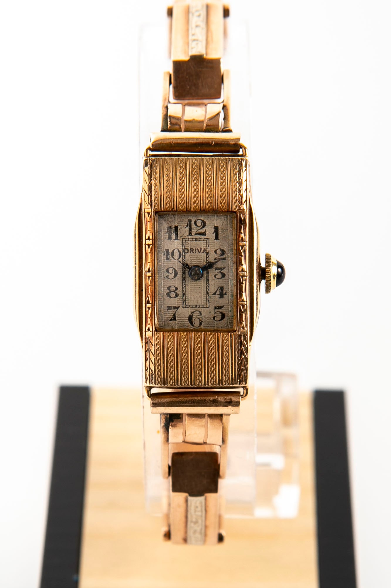 Antique women's wristwatch, circa 1920-1940, made of 14K gold, hallmarked, inlaid with a white gold: Antique women's wristwatch, circa 1920-1940, made of 14K gold, hallmarked, inlaid with a white gold band, the handle of the watch is set with a round sapphire stone with cabochon polishing, working co