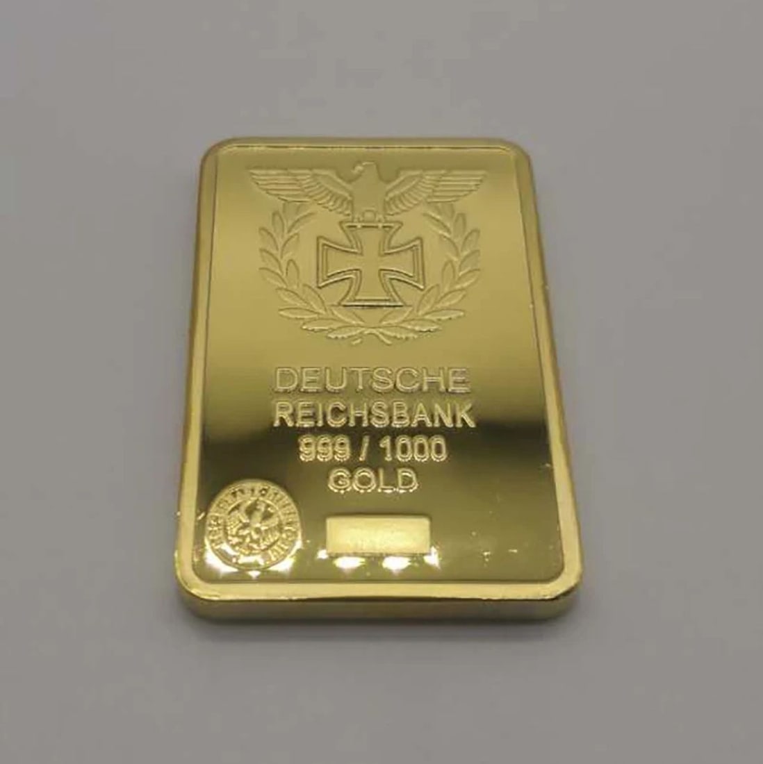 German Gilt Bullion Collectible Replica Eagle Bar: Size: Width 2.8 cm - Height 5 cm - Thickness 0.3 cm. Materials: Metal with plated gold (gilt). Condition: New. This gold-plated metal replica of a German Gold Bullion Bar pays homage to the historic D