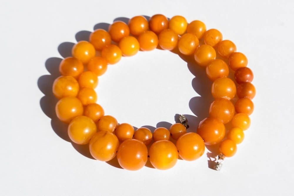 Egg yolk beads Vintage antique Necklace 100% Natural Baltic Amber: Weight: 54 gram (1.90 oz.) Beads size: 9-17 mm. Length: 550 mm Stone: 100% natural Baltic amber Treatment: no Condition: as on the photo The 100% natural Baltic amber floating in salt water has a plea