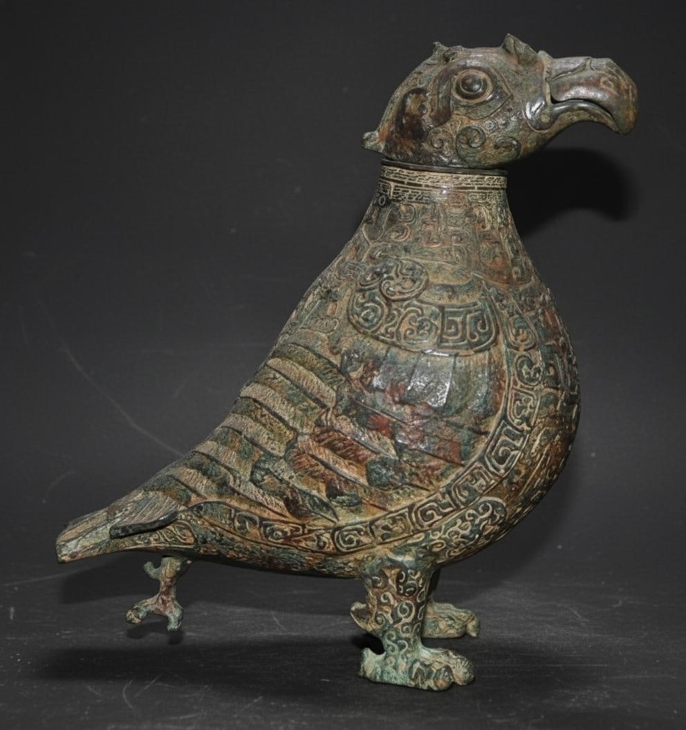 Unique Carved Bronze Chinese Bird Vessel Statue: Size: Height 26 cm - Length 23 cm - Width 13 cm. Weight 3.2 kg. Materials: Bronze. Condition: Appears to have a classic aesthetic. This retro-style piece is a unique Chinese bird vessel, traditionally