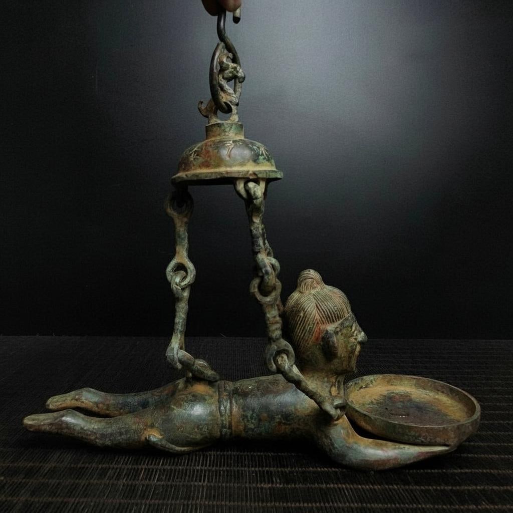 Candle Holder Vintage Bronze Lying Man Statue: Size: Height 25 cm - Length 26 cm. Weight 1 kg. Materials: Bronze. Condition: Excellent. This retro-style bronze candlestick, crafted in the tradition of China's Warring States period, is a captivatin