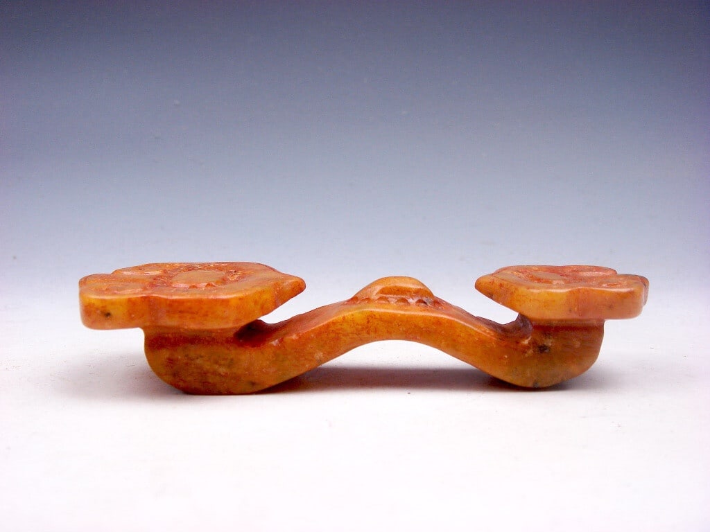 Retro Style Jade Scepter Blessing Carved Sculpture: Size: Height 2 cm - Length 11.2 cm - Width 4.2 cm. Materials: Jade. Condition: Appears to have a classic aesthetic. This retro-style sculpture depicts a Zhu-Yi scepter carved from orange jade. It is a