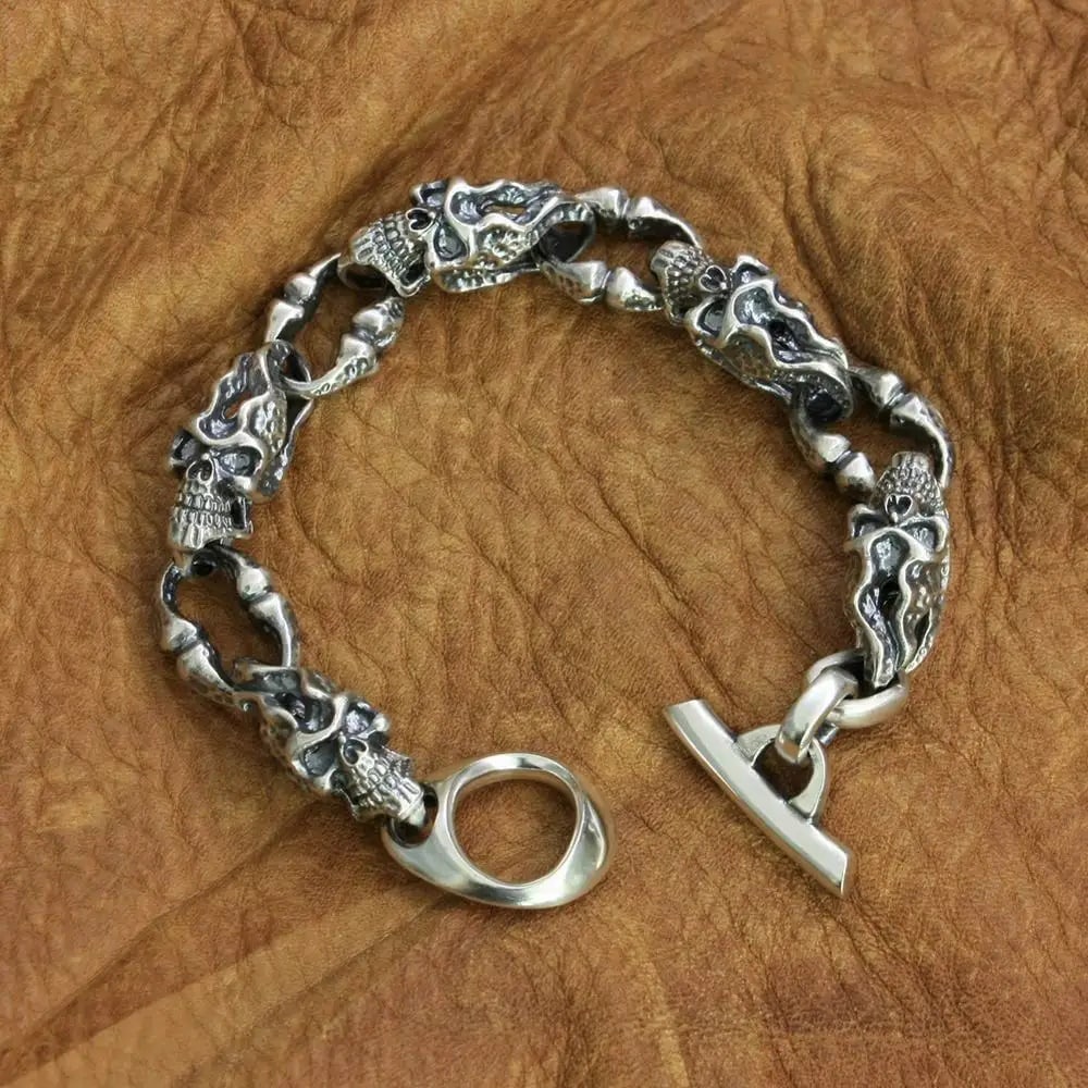 Retro Chunky 925 Silver Skull Chain Bracelet Biker: Size: Length 25 cm - Link Length 3 cm. Weight 77 g. Materials: S925 silver. Condition: New. This bracelet is crafted from 925 sterling silver and features a heavy chain of interlocking skull heads.