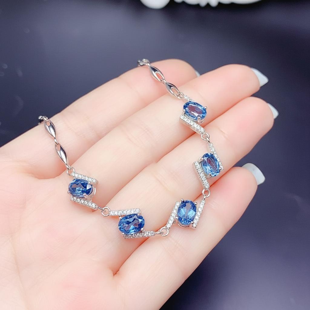 Blue Topaz S925 Silver Bracelet Retro Style: Size: Stone size 7 x 5 mm. Materials: S925 sterling silver, topaz, zircon. Condition: New. This vintage style bracelet is crafted from S925 sterling silver and features a series of blue topaz
