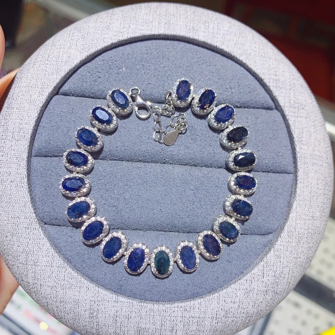Court Style Sapphire Blue Oval Bracelet Silver 925: Size: Length 17 cm - Stone size 6 x 4 mm. Materials: 925 sterling silver, sapphire, zircon. Condition: New. This bracelet is crafted from 925 sterling silver and features a series of oval-cut dark