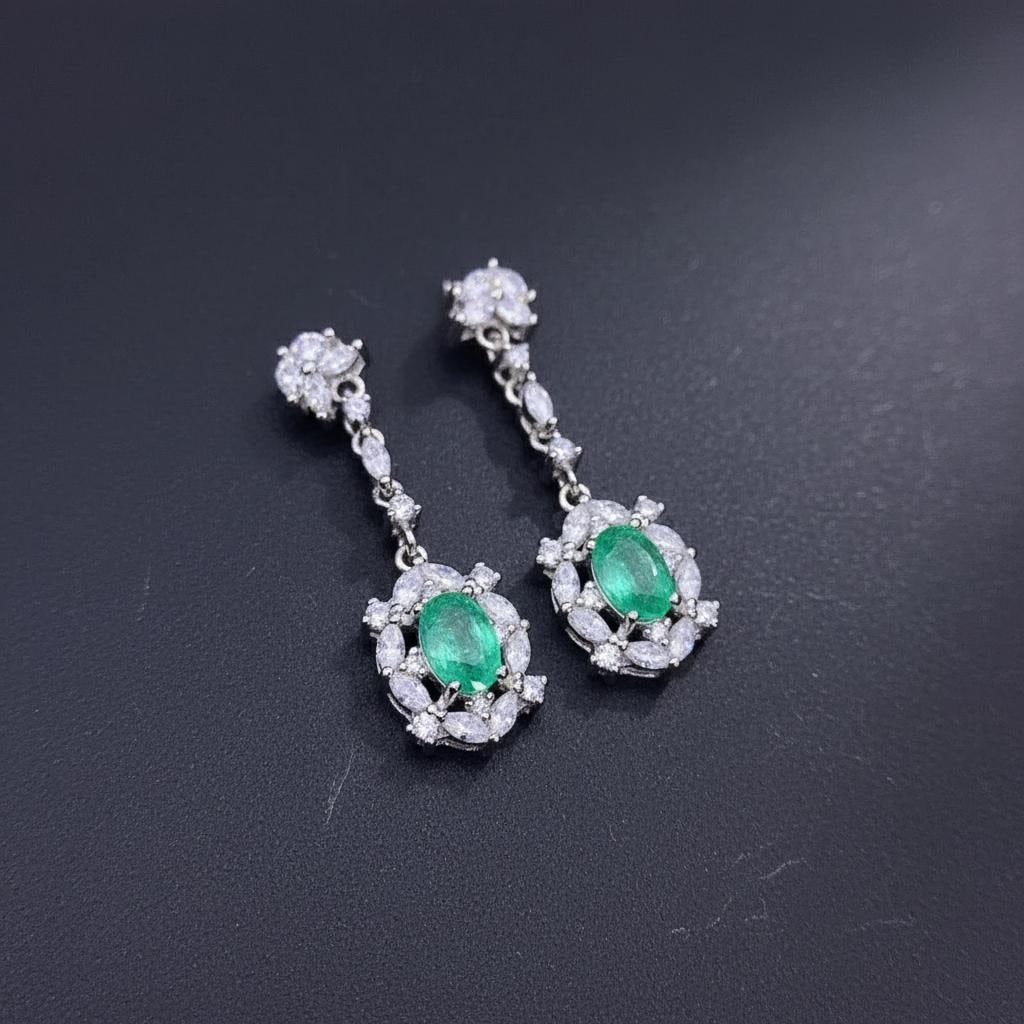Emerald Drop Earrings Silver 925 Vintage Style: Size: Stone size 6 x 4 mm. Weight 15 g. Materials: 925 sterling silver, emerald, zircon. Condition: New. This pair of drop earrings is crafted from 925 sterling silver and features oval-cut green
