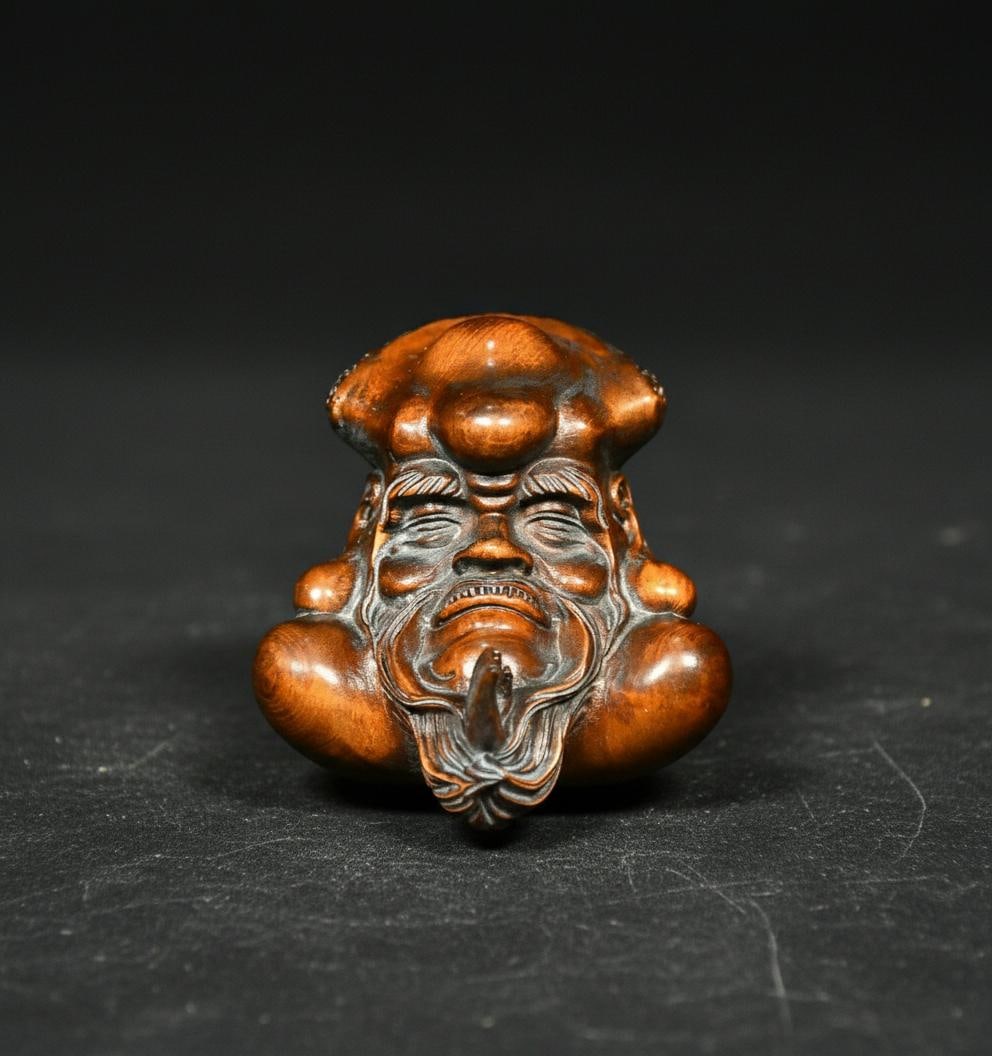 Retro Netsuke Pendant Boxwood Buddhist Rohan Face: Size: Height 5.8 cm - Length 4.8 cm - Width 7.4 cm. Weight 0.4 kg. Materials: Boxwood. Condition: Excellent. This is a small, hand-carved boxwood head statue depicting Damo (Bodhidharma), who is also