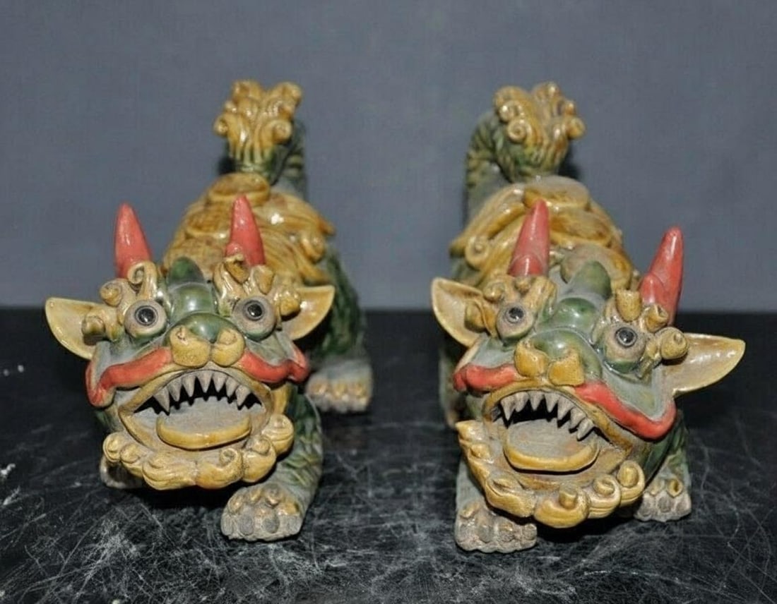 Colored Pair Chinese Porcelain Foo Dog Statues: Size: Height 14 cm - Length 20 cm - Width 9 cm. Weight 2.4 kg. Materials: Porcelain. Condition: Looks like vintage. This pair of statues depicts traditional Chinese guardian lions crafted from porcela
