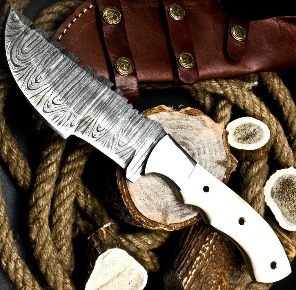 Camel Bone Handle Damascus Blade Tracker Knife: Size: Length 29.2 cm - Blade 14.6 cm. Materials: Damascus steel, camel bone, leather. Condition: New. This handmade tracker knife features a robust fixed blade forged from Damascus steel, displaying