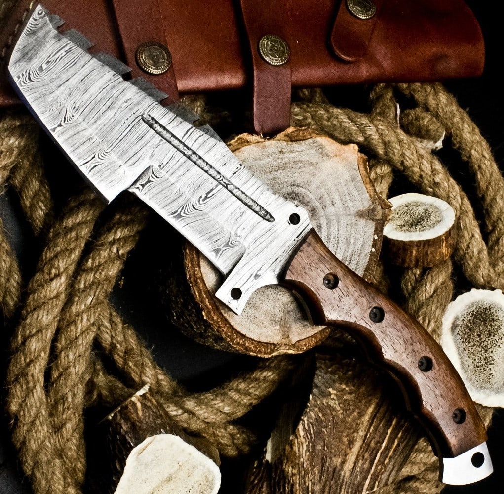 Rare Hard Wood Grip Damascus Tracker Knife Tool: Size: Overall Length 29.2 cm - Blade Length 14.6 cm - Handle Length 14.6 cm. Materials: Damascus steel, hard wood, leather. Condition: New. This handmade tracker knife features a robust blade forged