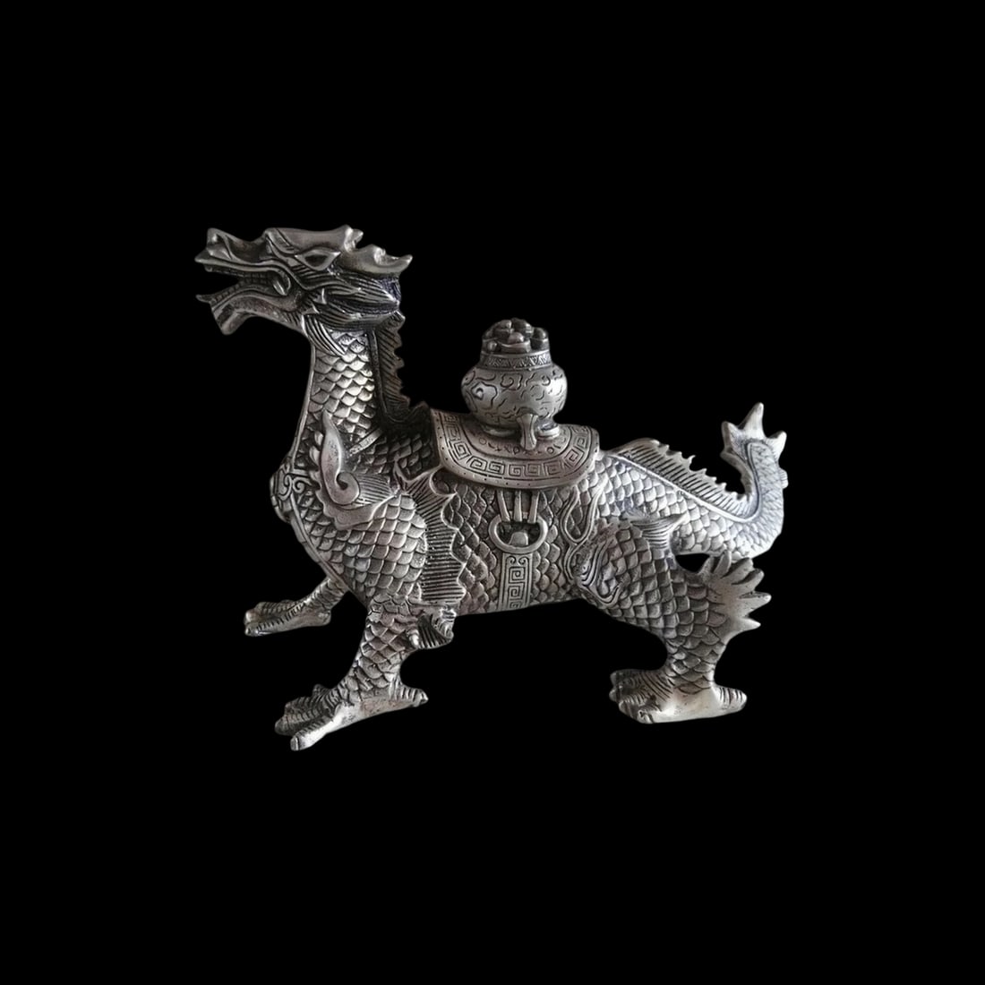 Chinese Tibetan Silver Motif luck Dragon Figurine: Size: Height 16.3 cm - Length 25 cm - Width 11 cm. Materials: Tibetan Silver (alloy of tin with copper or zinc). Condition: Appears to have a classic aesthetic. This impressive "lucky dragon" statue