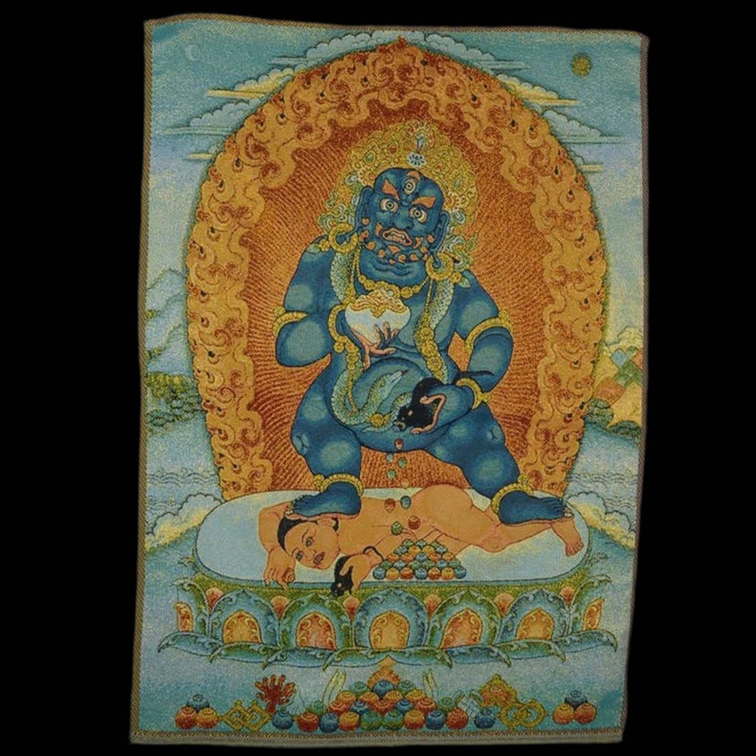 Oriental Vintage Style Jambhala Motif Thangka: Size: Height 60 cm - Length 40 cm. Materials: Silk. Condition: Excellent. This ritual thangka is inspired by the Tibetan Buddhist tradition, depicting the sacred black Jambhala, a powerful god of