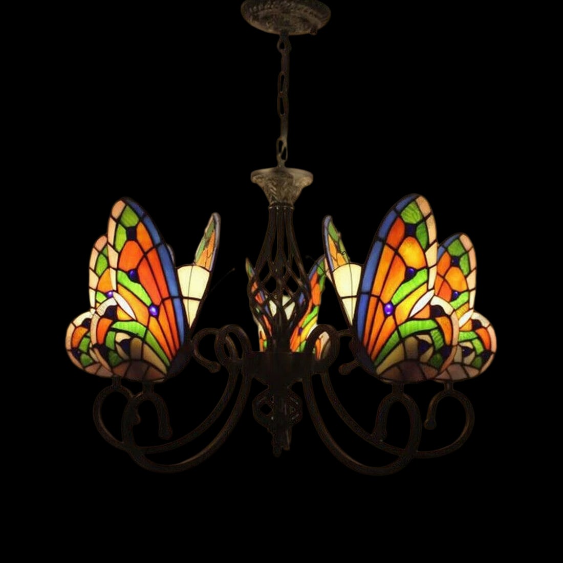 Hanging Chandelier Bugs Pattern Tiffany Style: Size: Height 75 cm - Width 68.5 cm. Materials: Art glass, metal hardware. Condition: New. This Tiffany-style Butterfly Chandelier is a masterfully crafted lighting fixture with a bold structural profi