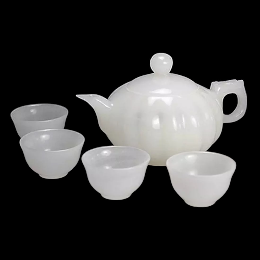 Chinese White Jade Hand-Carved Tea Dishes Set: Size: Teapot Height 7 cm - Teapot Length 12 cm. Materials: Jade. Condition: Resembles a retro aesthetic. This Chinese white jade hand-carved tea dishes set showcases the beauty of traditional
