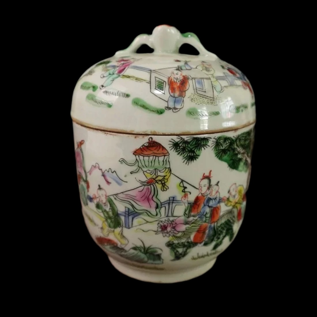Tradition-Style Porcelain Tea Jar Landscape Scene: Size: Height 16 cm - Width 12.3 cm. Materials: Porcelain Condition: Excellent The cylindrical vessel features a gently tapered base and a domed lid crowned with a sculpted, green-accented finial. Its 