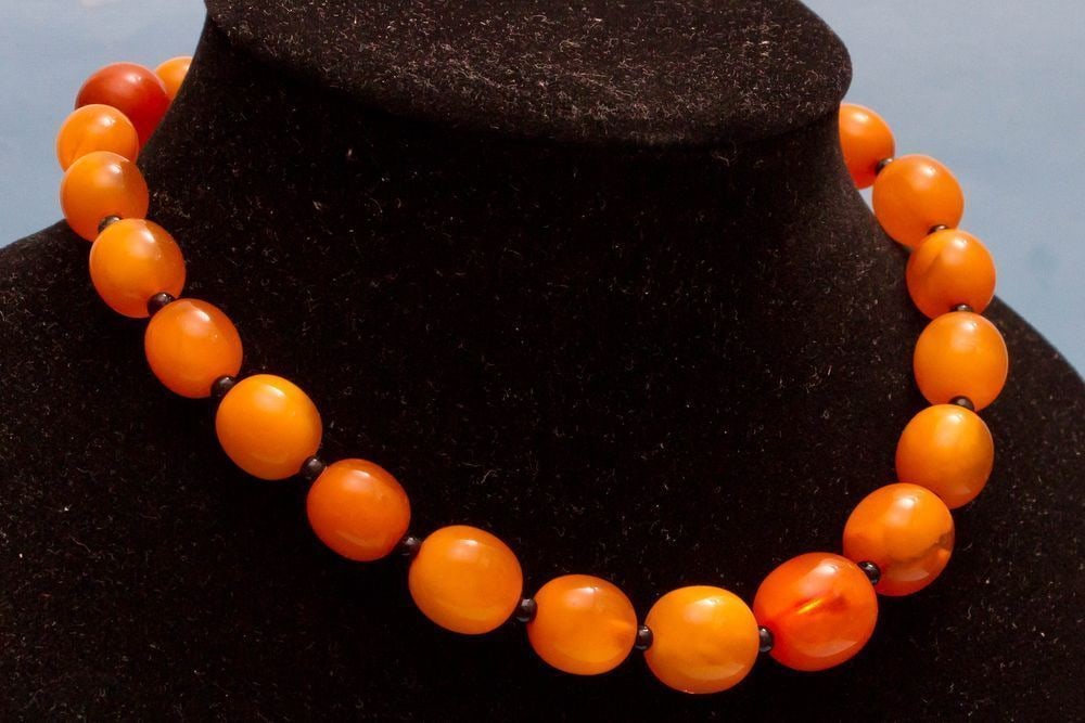 Authentic Vintage Baltic Amber Necklace with Egg Yolk Round Beads: Vintage necklace made from 100% natural Baltic amber, weighing 42g, featuring round beads that highlight its timeless beauty. Weight: 42 gram (1.48 oz) Beads size: 11-17 mm. Length: 430 mm Stone: 100%