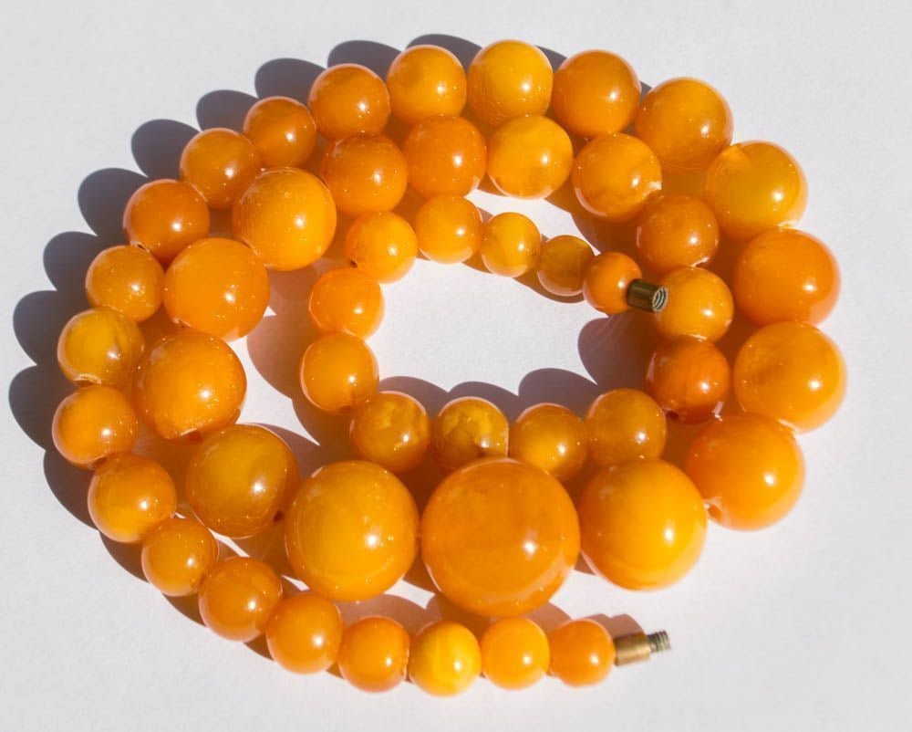 Luxurious Vintage Natural Baltic Amber Necklace in Orange and Yellow Hue: Genuine Baltic Amber: 50.78g Vintage Necklace in Orange and Yellow Weight: 50.78 grams Bead Size: 7-19 mm Length: 540 mm Stone: 100% Natural Baltic Amber Treatment: None Condition: As shown in the pho