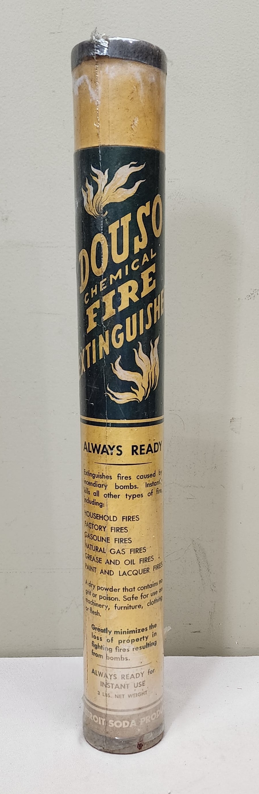 Douso Chemical Fire Extingusisher Tube: Large cardboard tube type fire extinguisher made by the Detroit Soda Products Company. This large tube stands 20 1/2" tall. It is in good overall condition with some fading to the graphics.