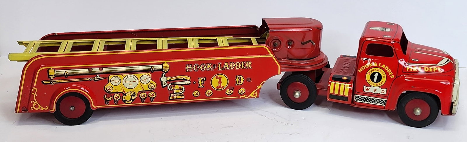 Tin Wyandotte Fire Ladder Truck: Tin Wyandotte ladder truck 23 in length. Complete with tools