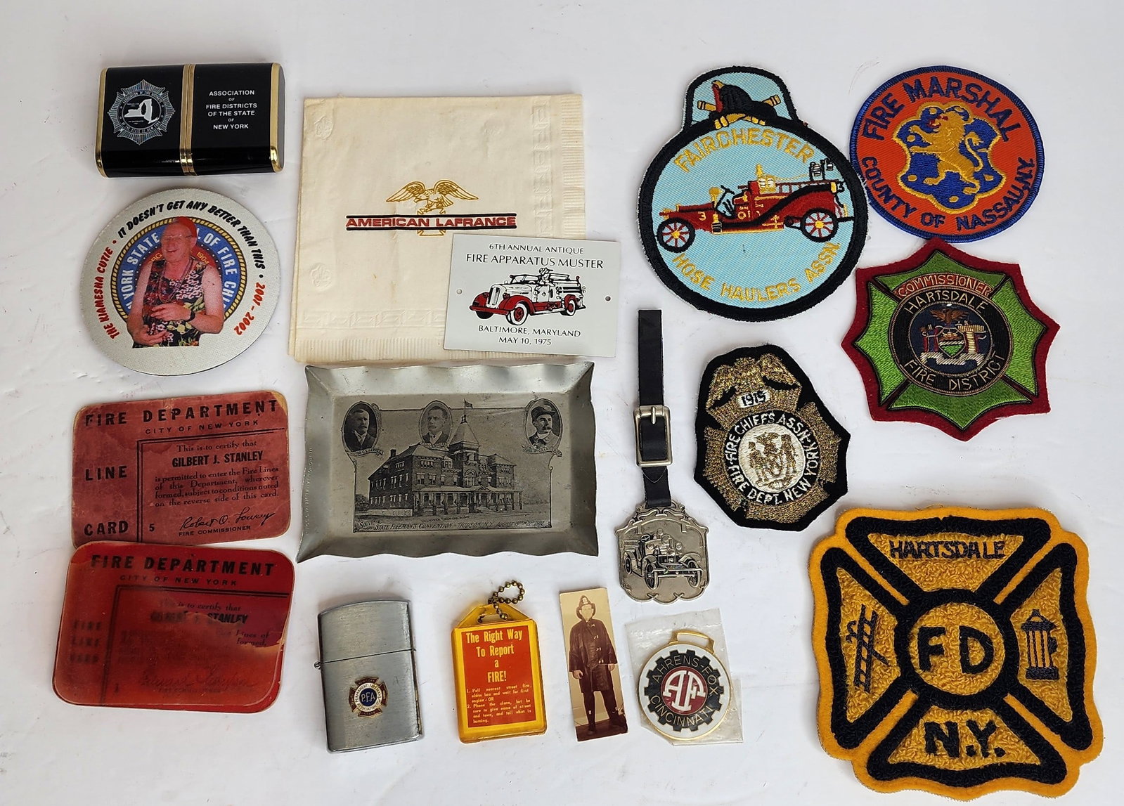 Lot of Firefighting Items Including FDNY: Lot includes FDNY Fire Line passes, Hartsdale NY patches, Ahrens Fox fobs, 1902 New York Fire Convention aluminum tray