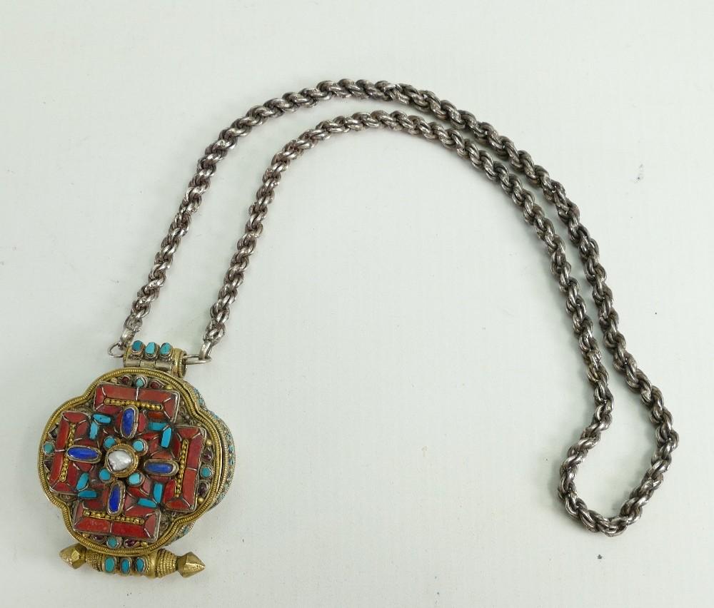 Oriental silver coloured metal and gilt opening locket: Oriental silver coloured metal and gilt opening locket shrine on heavy silver chain: Shrine measures 5.5cm x 7cm high. Set with various gemstones including Jasper & Lapiz Lazuli.