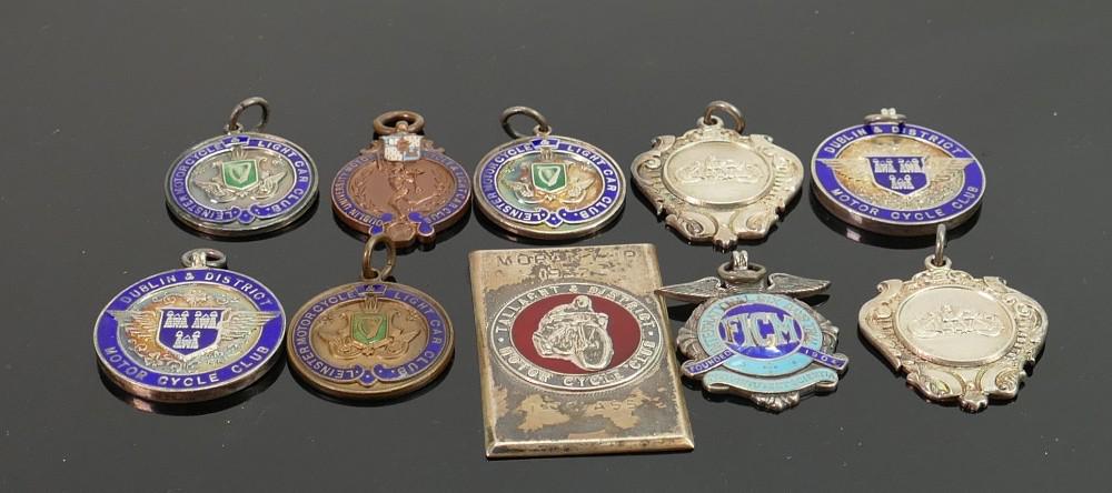 A collection of silver motorcycle medals: comprising: A collection of silver motorcycle medals: comprising enamelled Silver medals dating from 1930s awarded to H E Hamilton from Dublin,Tallach and other Motorcycle clubs of Ireland, Silver weight 144g, 2 