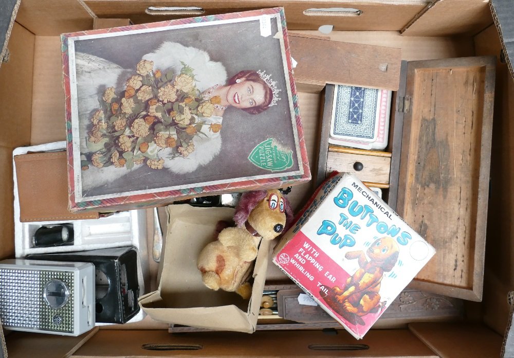 A mixed collection of items to include: Mechanical toy: A mixed collection of items to include: Mechanical toy dog, game sets , rosary beads, Pye pocket radio's etc