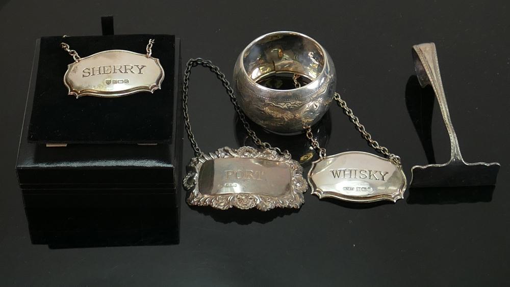 Group of silver including wine labels: Three assorted: Group of silver including wine labels: Three assorted hallmarked spirit labels, napkin ring a/f, and silver pusher. Weight 77g appx.
