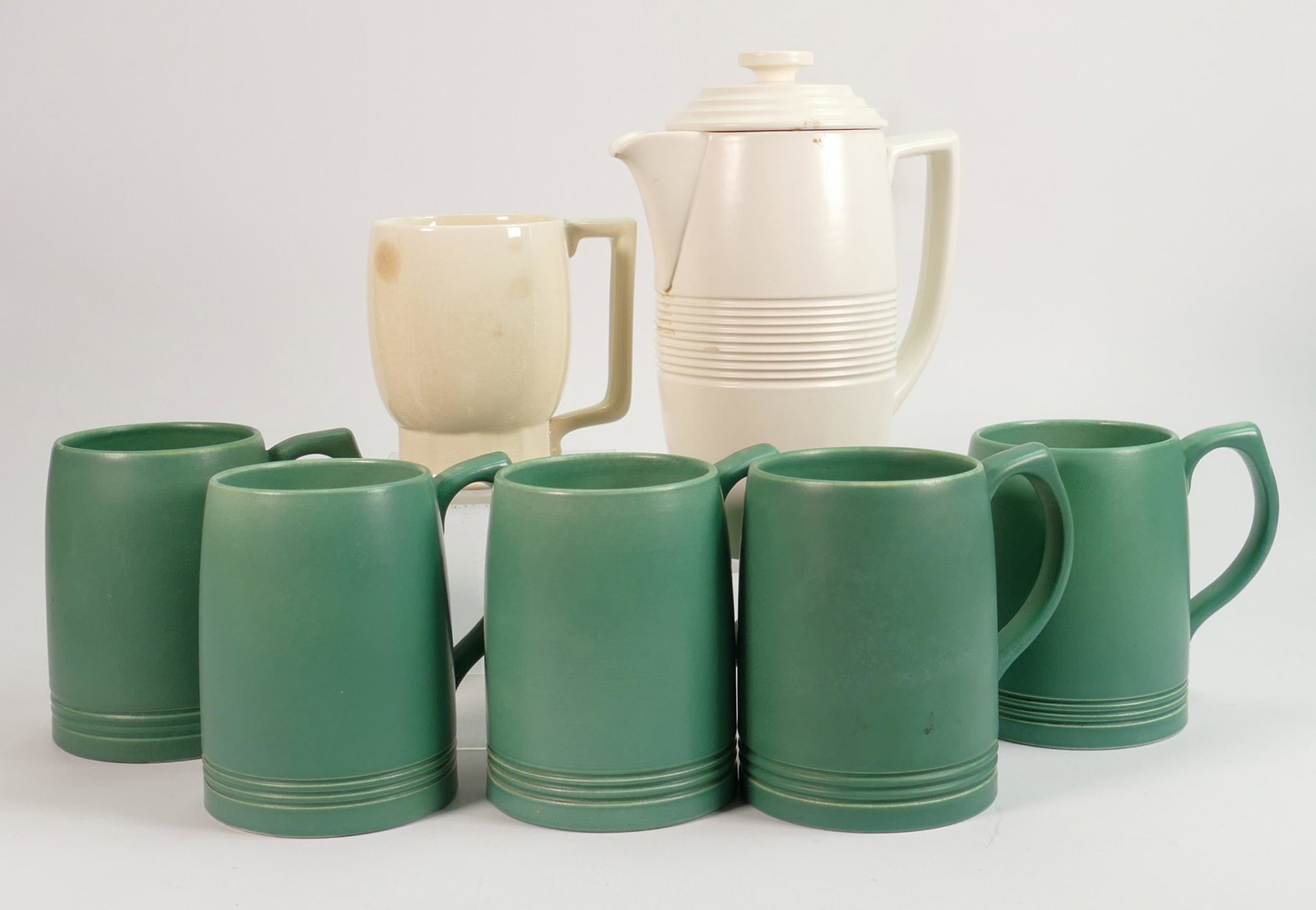 A collection of Wedgwood Keith Murray items to include:: A collection of Wedgwood Keith Murray items to include: Green tankards, tea pot (tiny nip noted to tip of spout), height of tallest 21cm. (7)