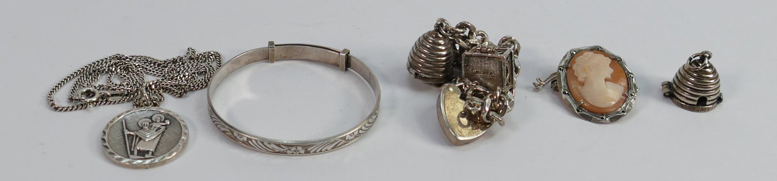 A collection of silver jewellery: including charm bracelet, cameo brooch, pendant & chain etc,: A collection of silver jewellery: including charm bracelet, cameo brooch, pendant & chain etc, 44.5g.