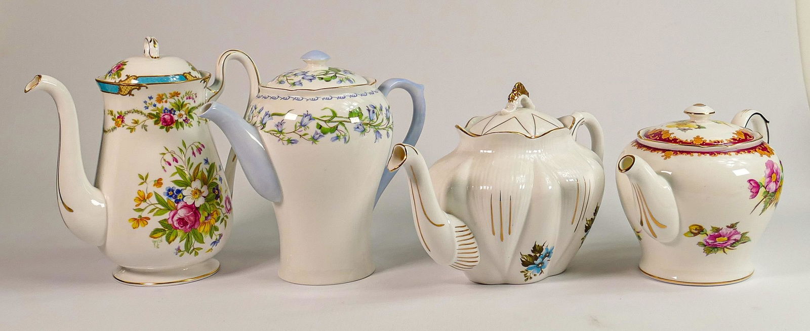Four Shelley tea & coffee pots including: Dainty shape with blue flowers, Henley shaped pattern (1 of 2)