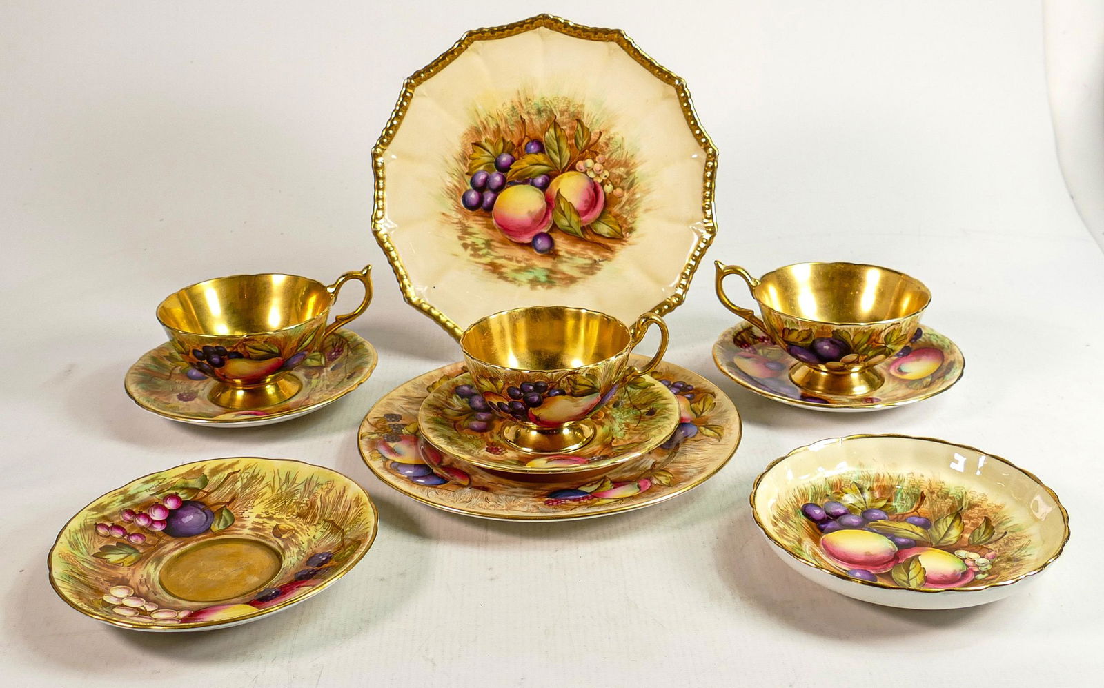 Aynsley Orchard Gold patterned items to include: Three cup & saucer sets, additional saucer, cabinet (1 of 2)