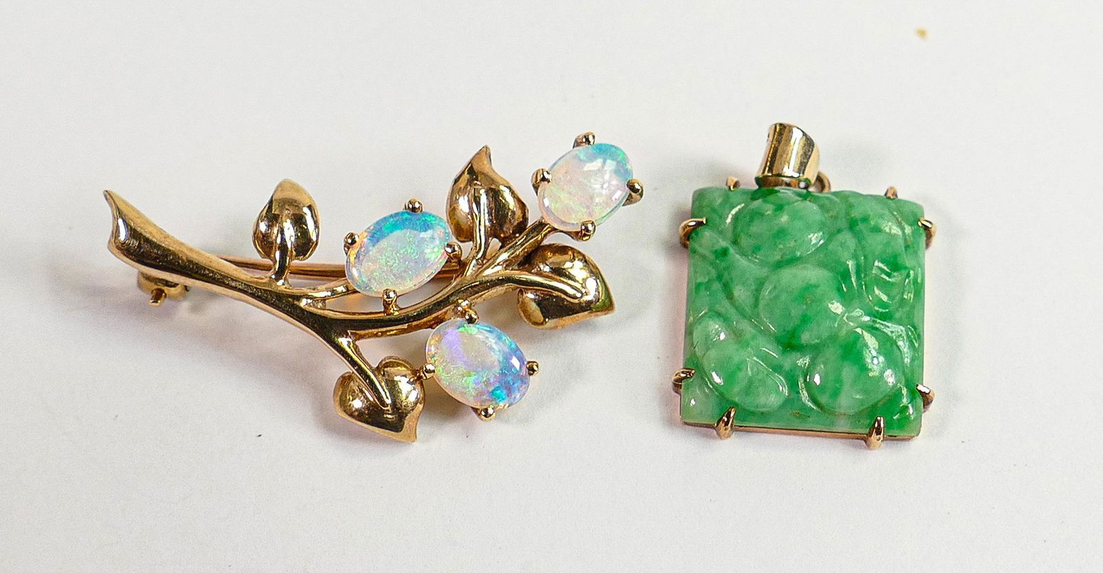 9ct hallmarked gold and opal brooch plus 9ct jade pendant: Gross weight 7.3g, brooch measures 34mm: 9ct hallmarked gold and opal brooch plus 9ct jade pendant: Gross weight 7.3g, brooch measures 34mm wide, the pendant 16mm wide. Both fully UK hallmarked.