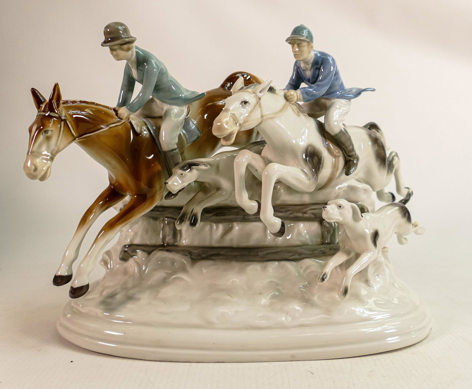 Carl Scheidig Grafenthal continental porcelain figure group of jumping huntsman & woman with hounds,: Carl Scheidig Grafenthal continental porcelain figure group of jumping huntsman & woman with hounds, height 21cm.