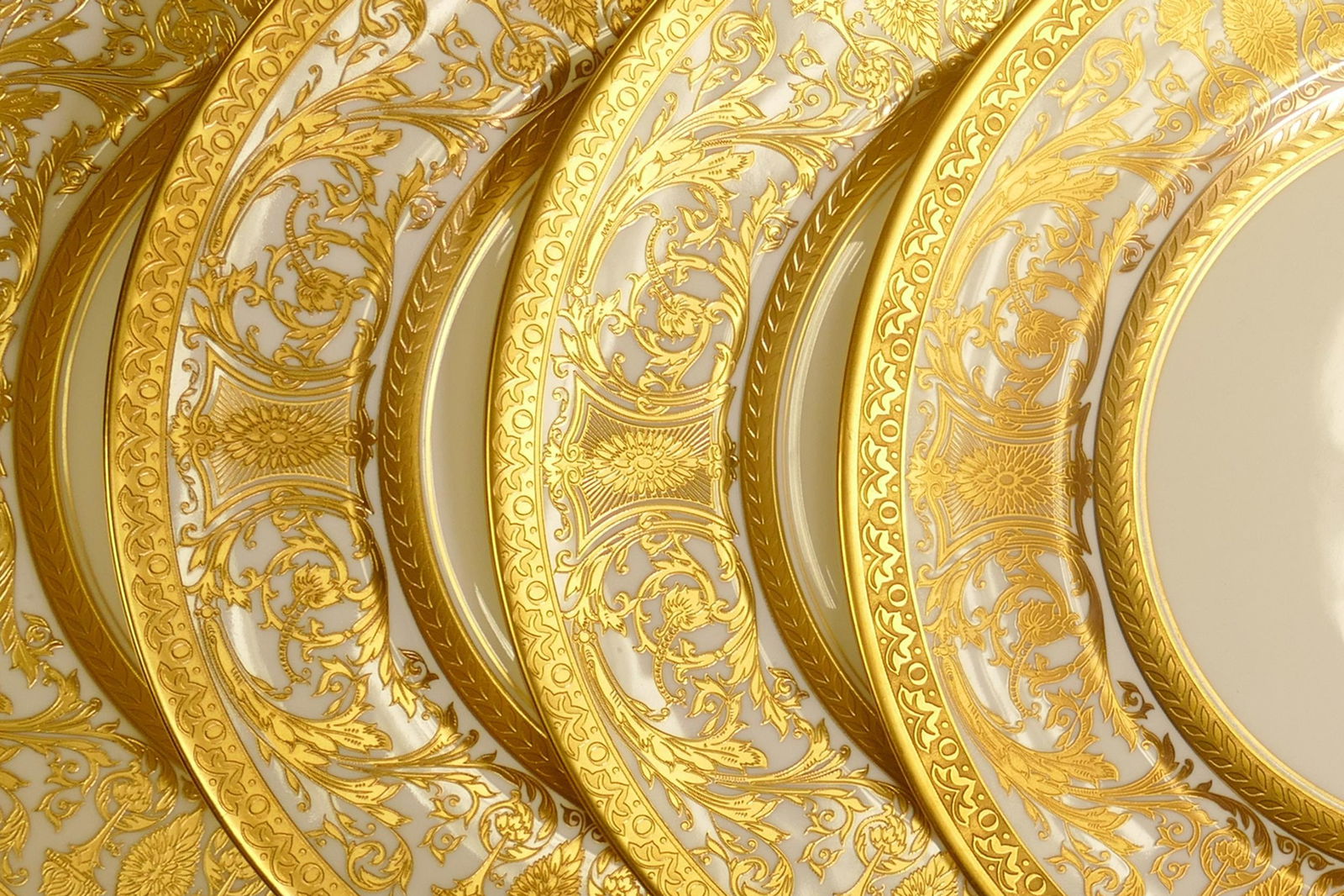 De Lamerie Fine Bone China heavily gilded Robert Adam patterned dinner plates, specially made high: De Lamerie Fine Bone China heavily gilded Robert Adam patterned dinner plates, specially made high end quality items, made in England, diameter 27cm. (4)