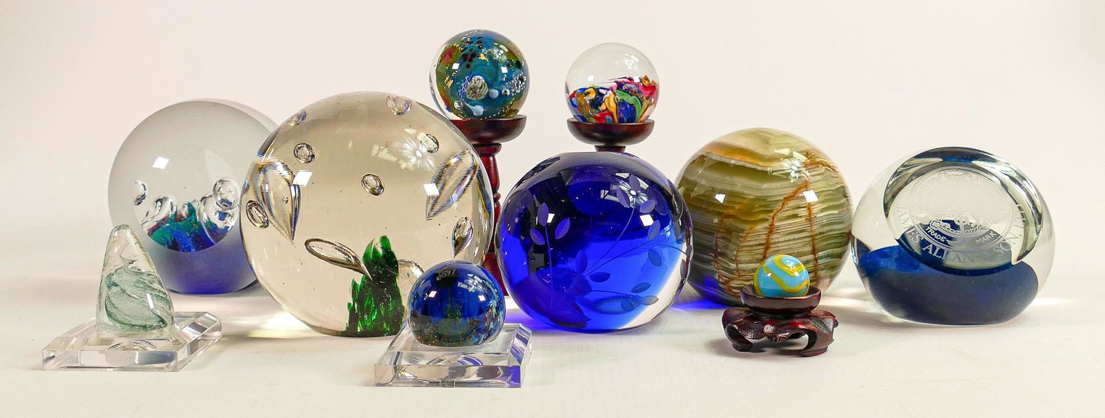 A collection of paperweights to include - Sylra, James Allen & Son Ltd., Inhabited Earth blown glass: A collection of paperweights to include - Sylra, James Allen & Son Ltd., Inhabited Earth blown glass paperweight by Josh Simpson signed and dated J S 97 with stand etc. (9)