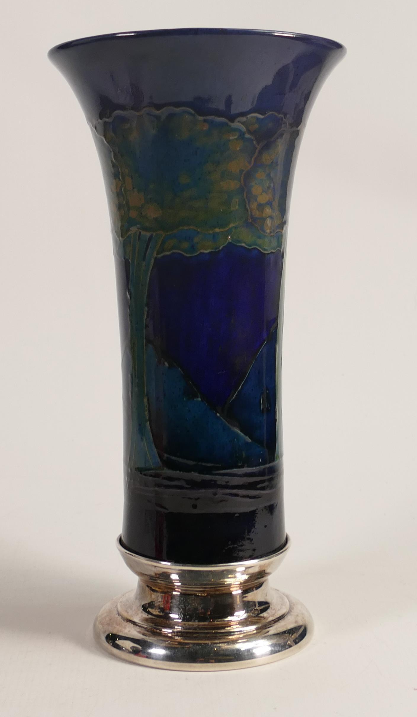 William Moorcroft large vase decorated in the Moonlit Blue design, with silver plated base, h.30cm.: William Moorcroft large vase decorated in the Moonlit Blue design, with silver plated base, h.30cm. Restoration to top edge area.