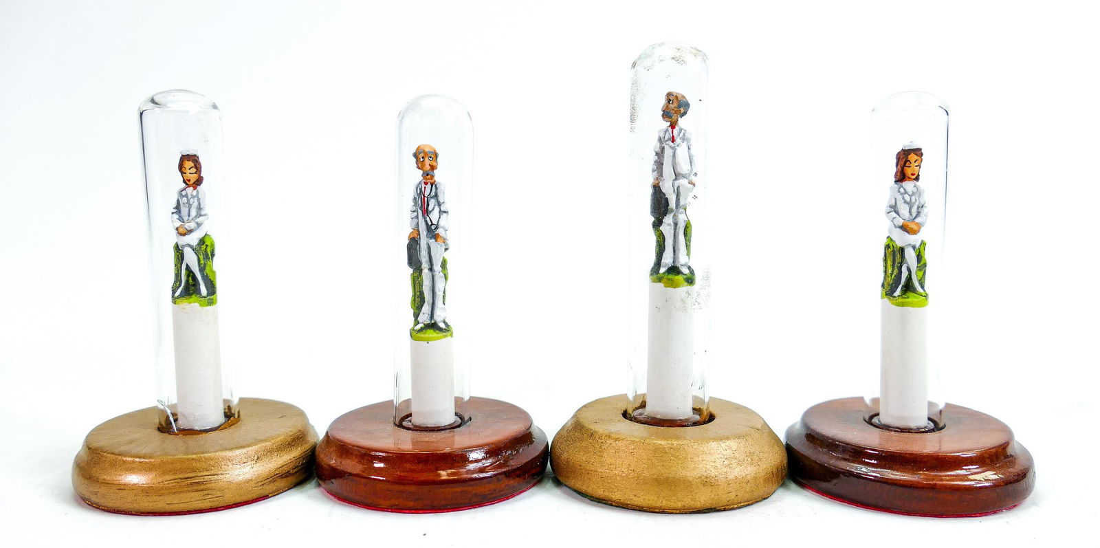 20th century studio pottery medical profession theme chess set, each piece held within glass test: 20th century studio pottery medical profession theme chess set, each piece held within glass test tube, Phillips Auctions lot 106 label noted, marked AMC to rear of king, height 9.4cm.