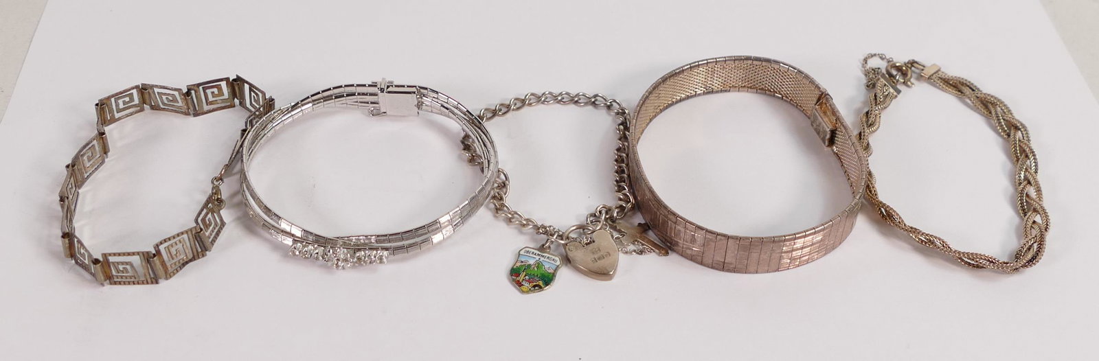 Three Silver bracelets, 800 Silver bracelet and white metal reversible asian bracelet, gross weight: Three Silver bracelets, 800 Silver bracelet and white metal reversible asian bracelet, gross weight 67g. (5)