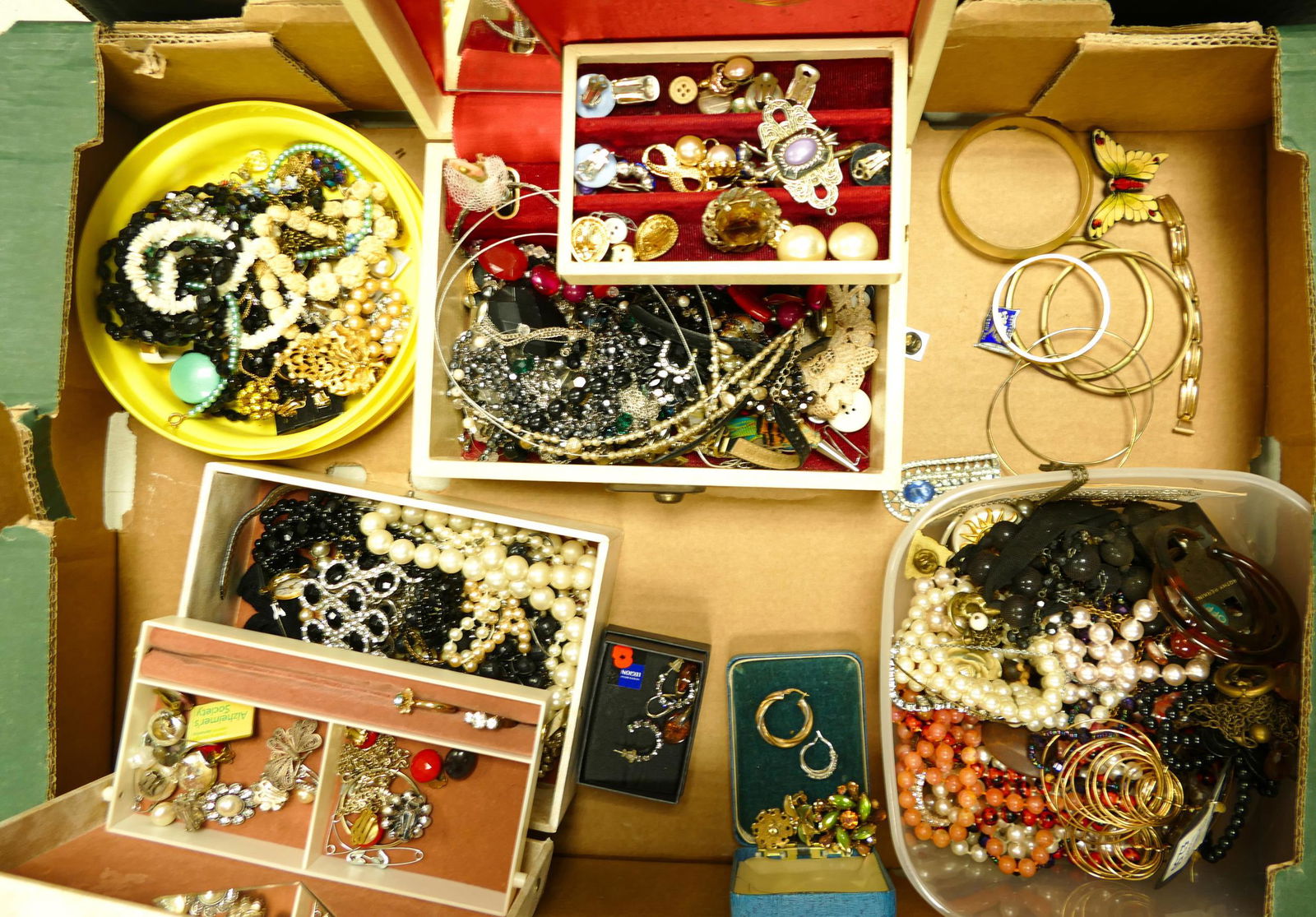 A large collection of costume jewellery including beads, brooches, chains, pendants, brooches, (1 of 1)