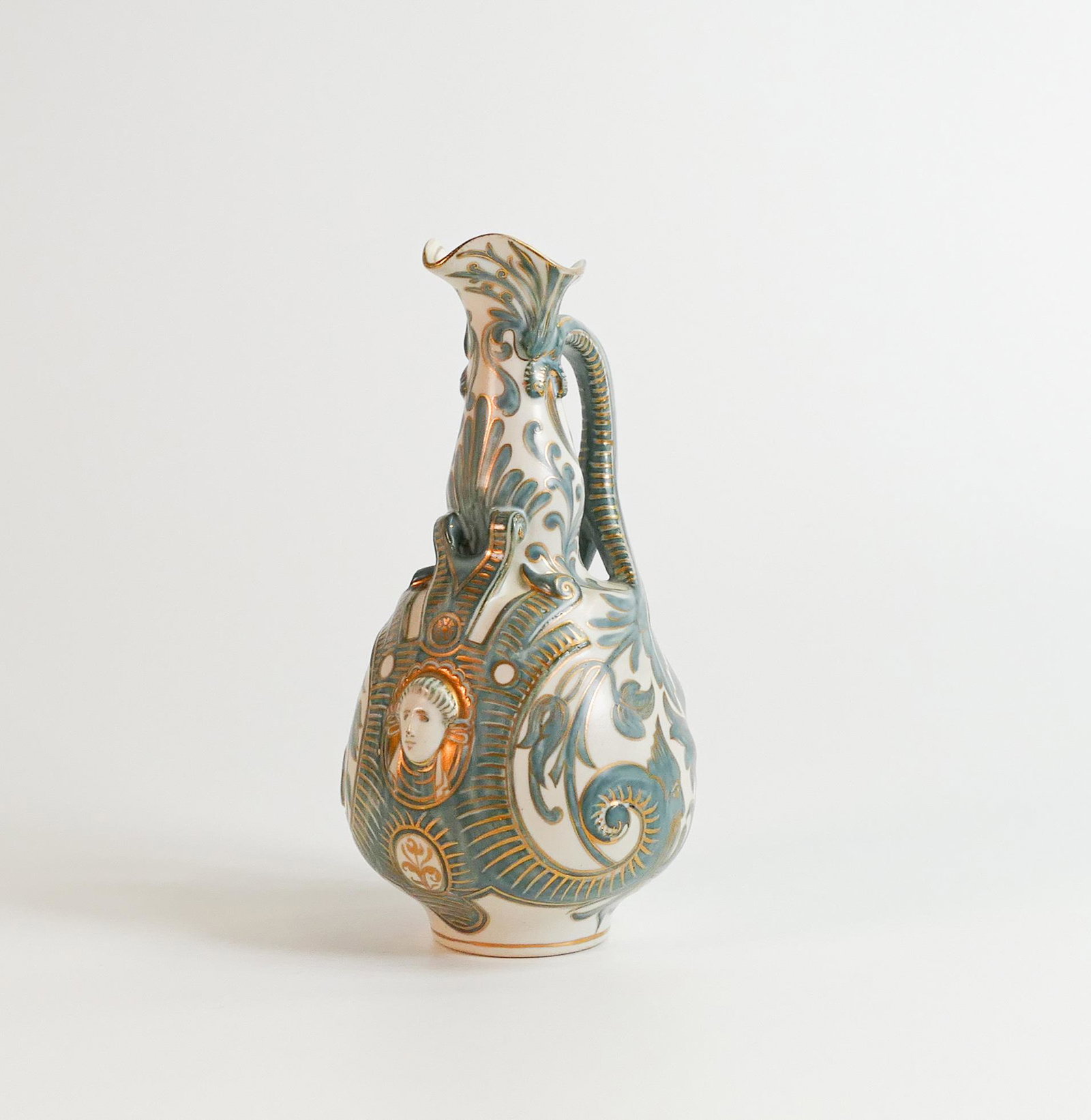 Doulton Lambeth Stoneware Carrara ware ewer, gilded & decorated with flowers and womens mask head,: Doulton Lambeth Stoneware Carrara ware ewer, gilded & decorated with flowers and womens mask head, h.18.25cm.