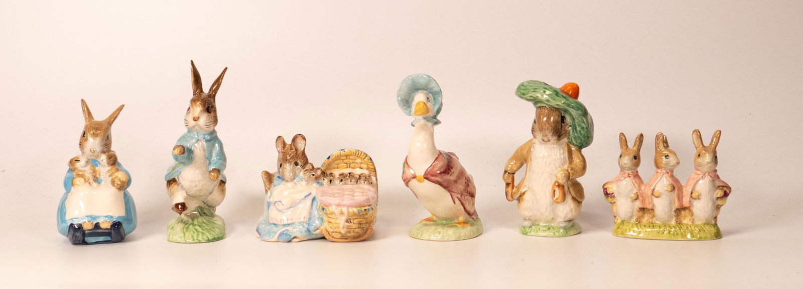 set of six Royal Albert Beatrix Potter figures to include Peter Rabbit, Mrs Rabbit & bunnies,: set of six Royal Albert Beatrix Potter figures to include Peter Rabbit, Mrs Rabbit & bunnies, Benjamin bunny, Jamima Puddleduck, Flopsy Mopsy & Cottontail and Hunca Munca. All BP5a with gold backstamp
