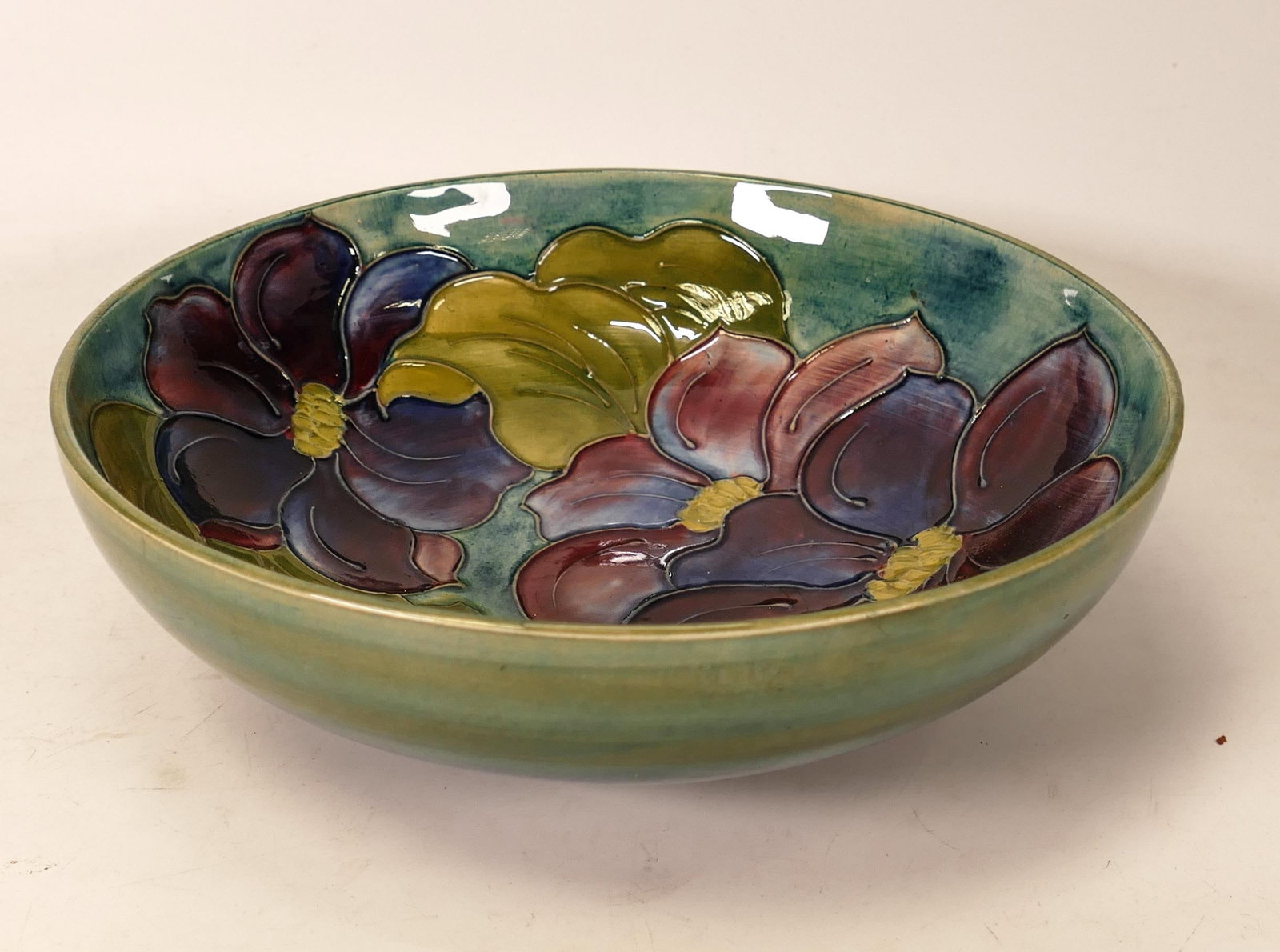 Moorcroft Clematis bowl on a faded green / blue background. Diameter 21cm: Moorcroft Clematis bowl on a faded green / blue background. Diameter 21cm