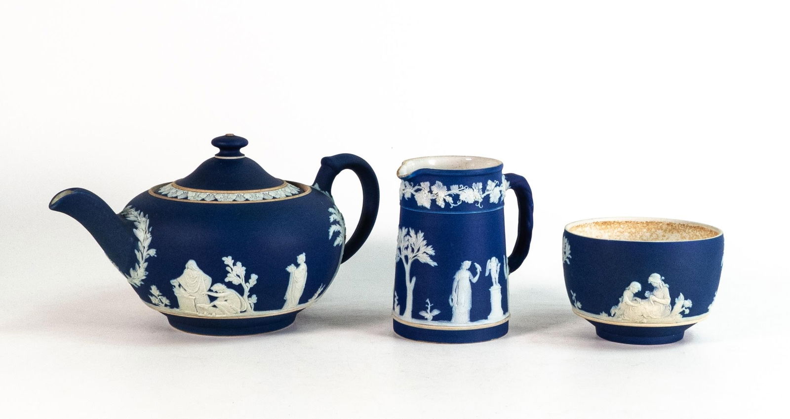 Wedgwood Dip Blue Jasperware c.1920 tea pot and milk jug decorated in white bas relief 'Sacrifice to (1 of 2)